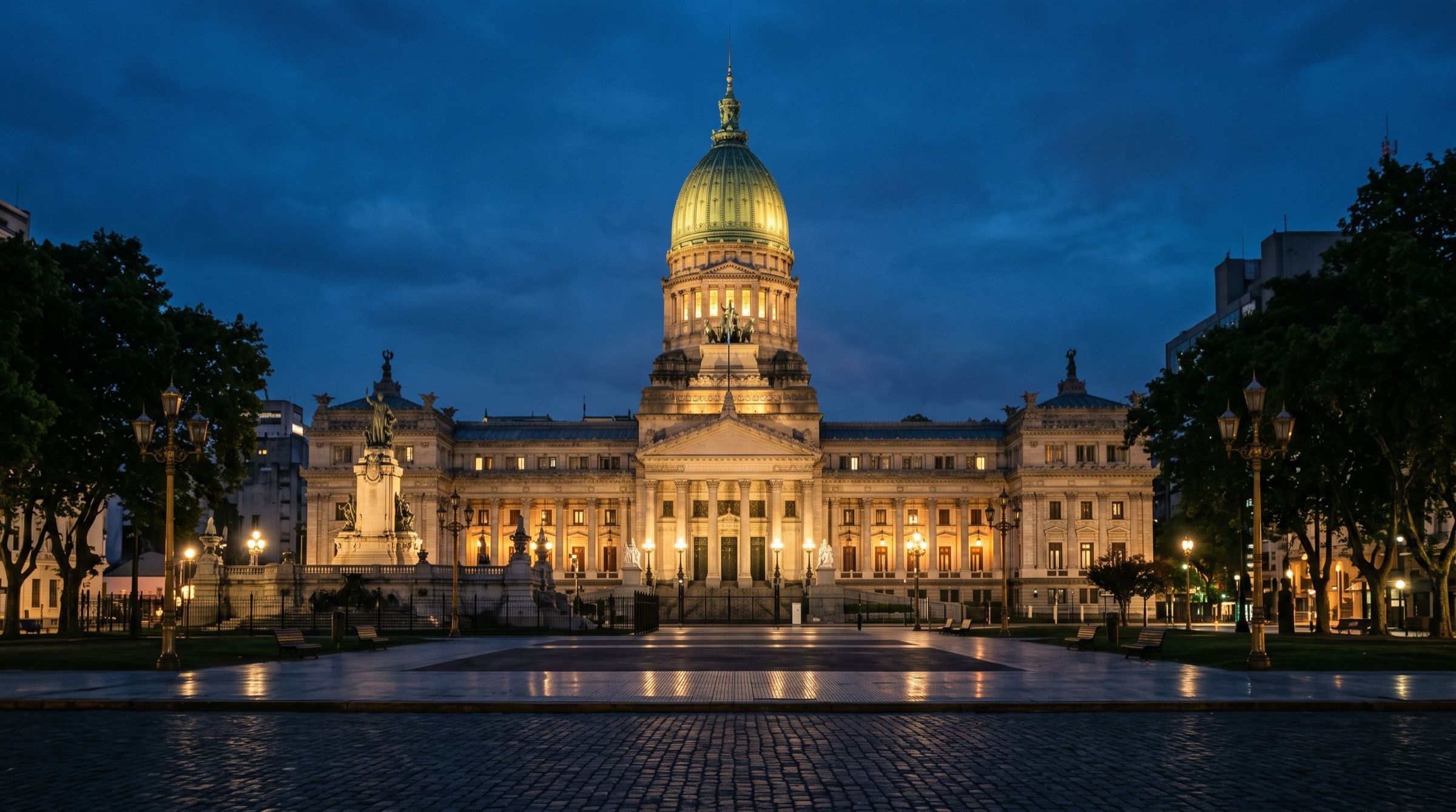 The Argentine National Congress building in Buenos Aires at dusk, its green dome lit warmly, an empty square in front