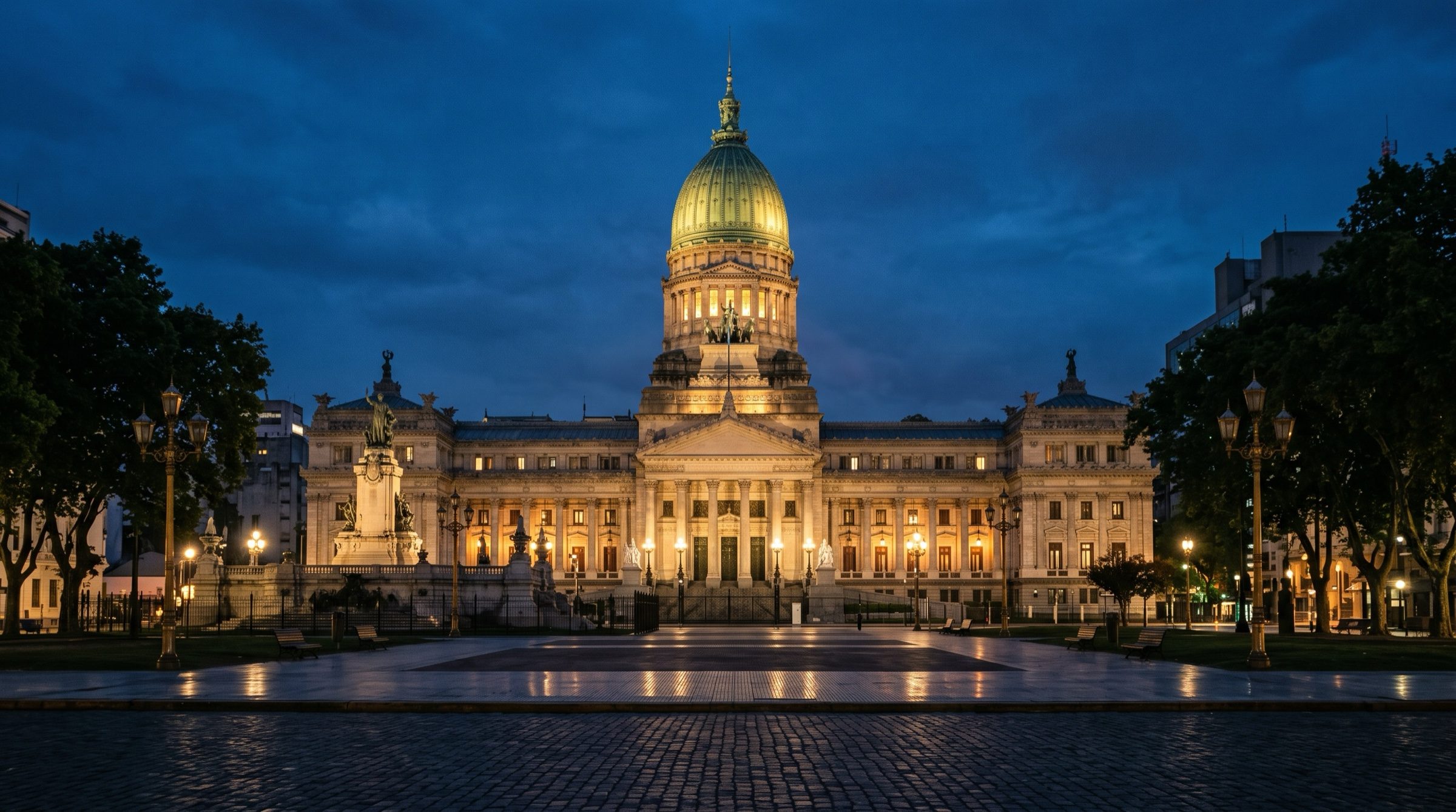 The Argentine National Congress building in Buenos Aires at dusk, its green dome lit warmly, an empty square in front