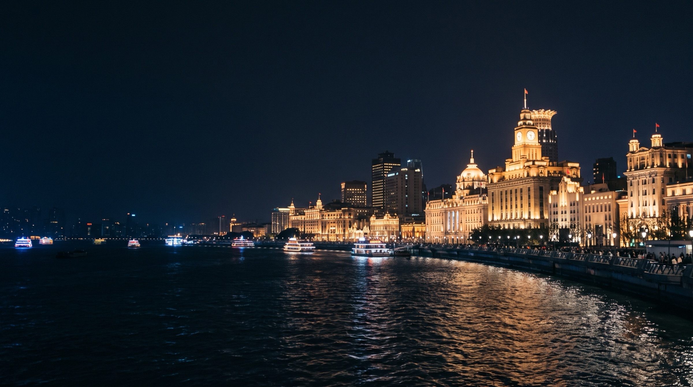 The Bund in Shanghai at night with the Huangpu river and illuminated historic facades