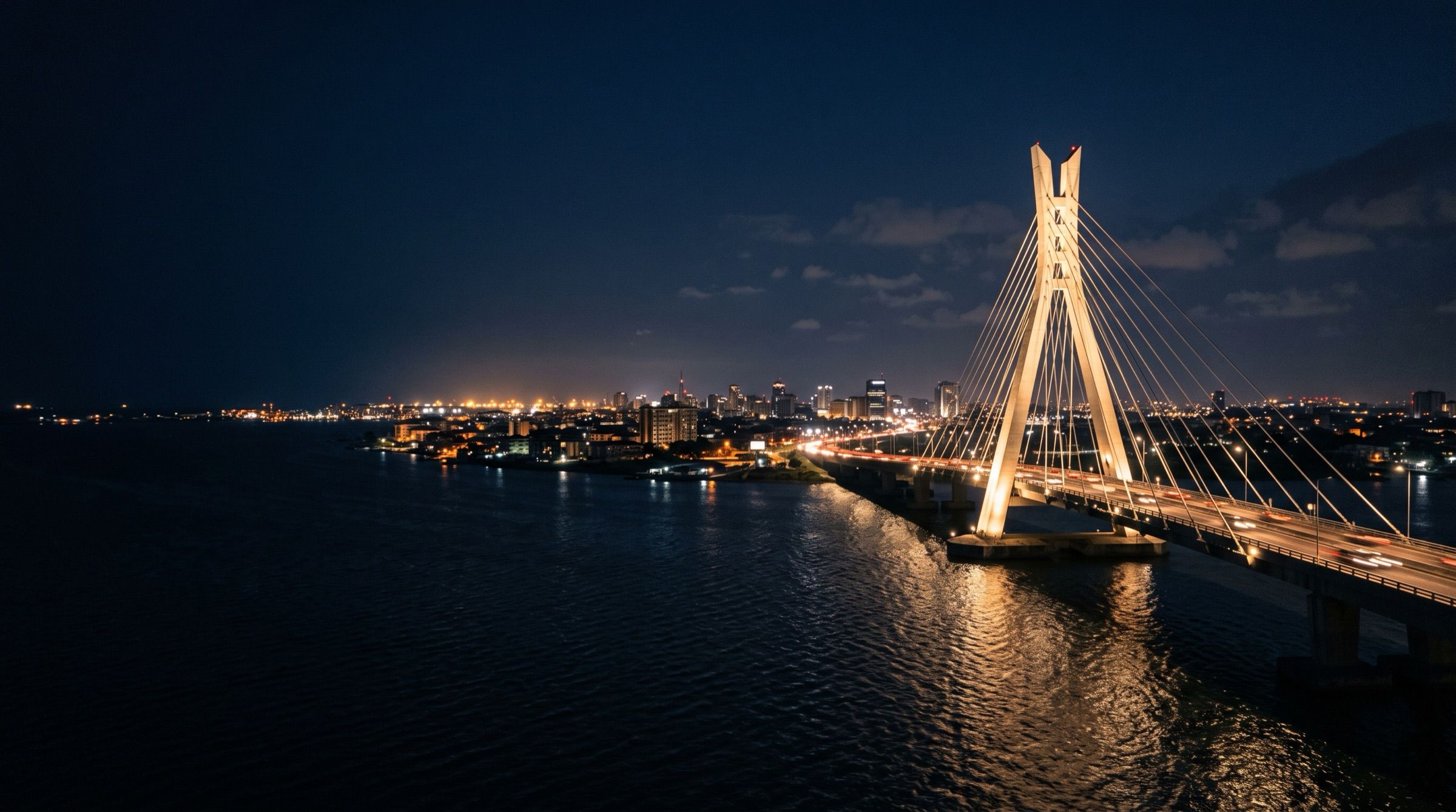 Lagos at night with the Lekki-Ikoyi cable bridge lit up over the lagoon