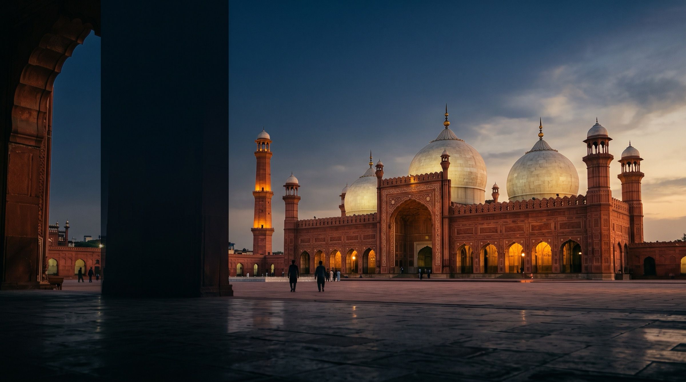 The Badshahi Mosque in Lahore at golden hour, red sandstone and white marble domes
