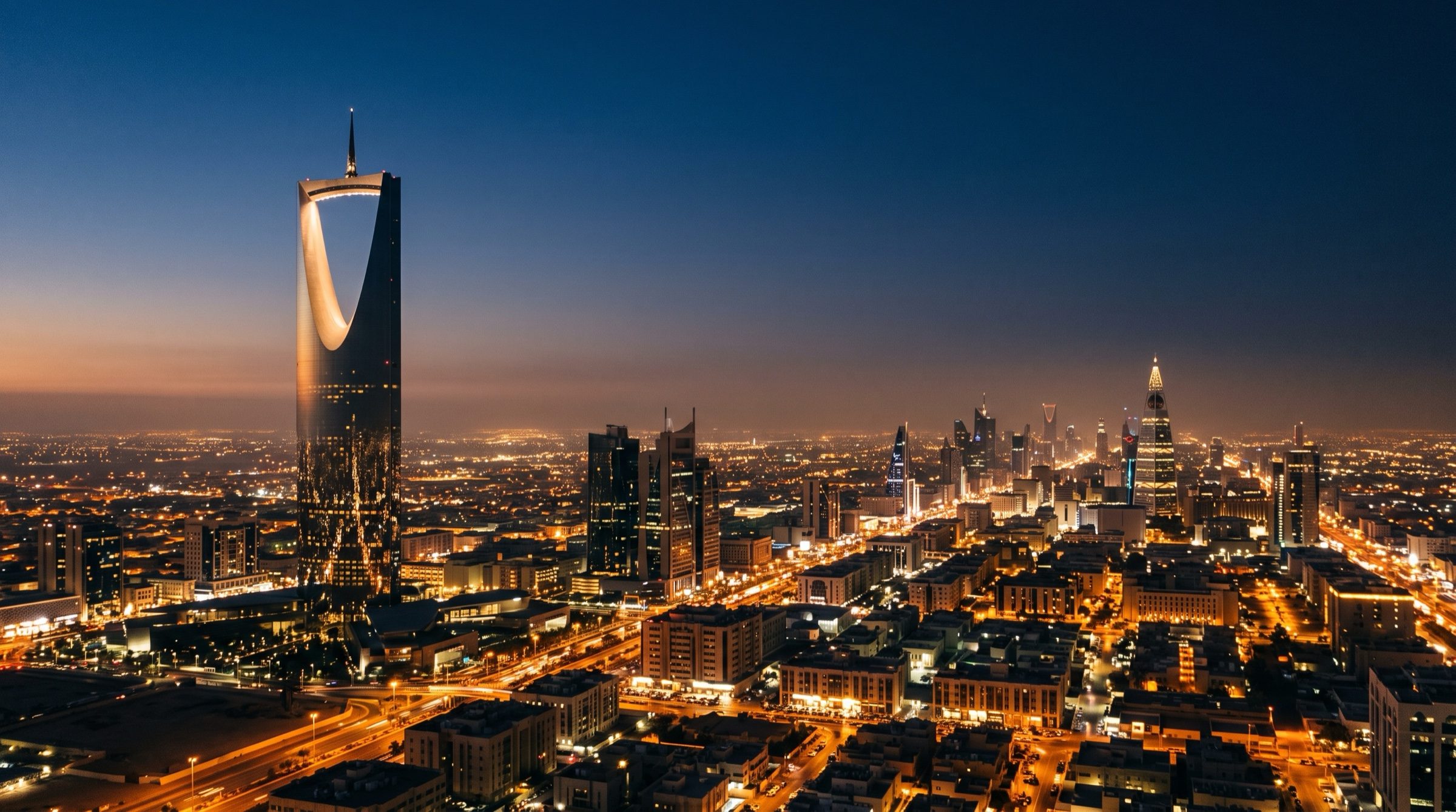 Riyadh skyline at blue hour with the Kingdom Centre tower silhouette and desert haze