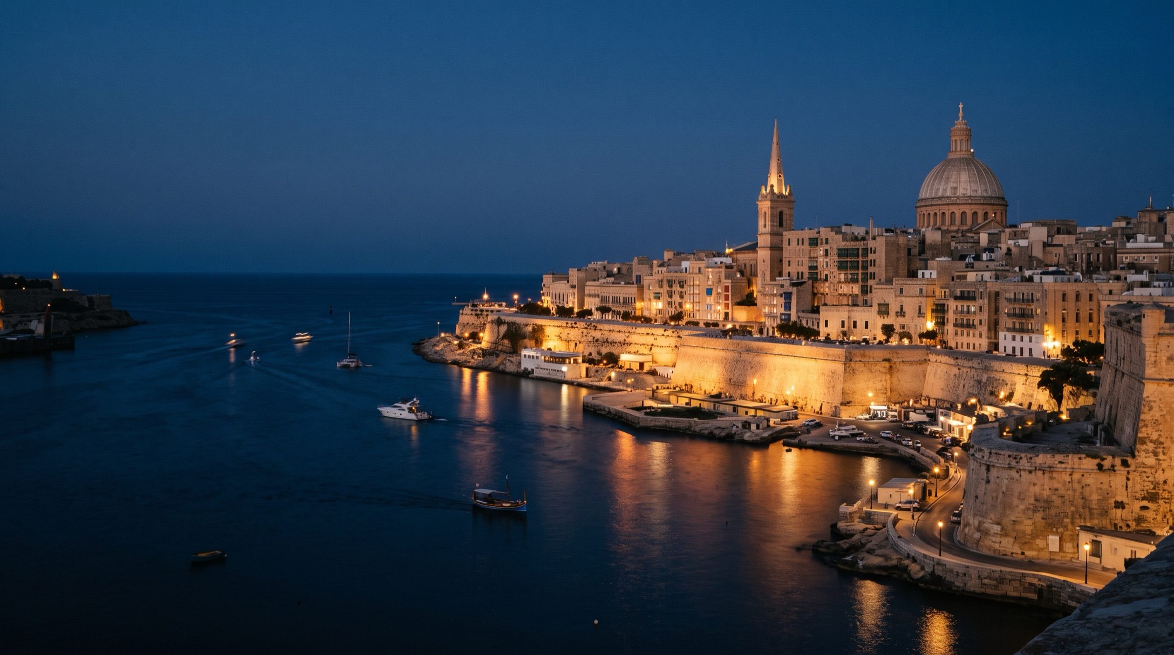 Valletta's honey-coloured limestone bastions and Grand Harbour at dusk